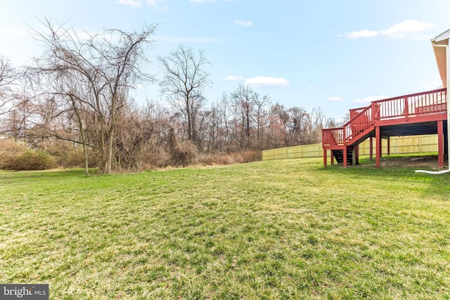 view of yard featuring a deck and stairway