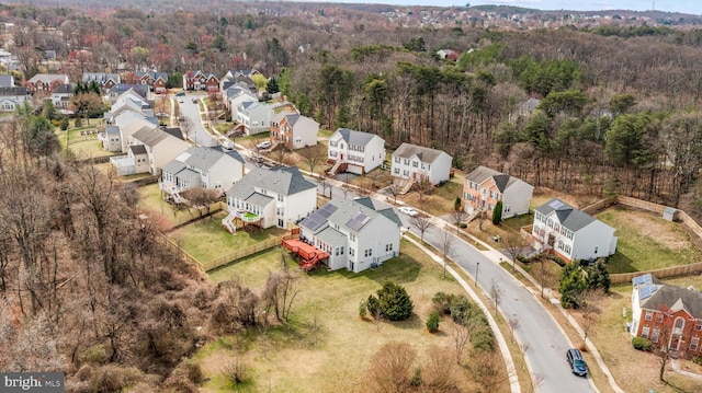 drone / aerial view featuring a residential view and a forest view