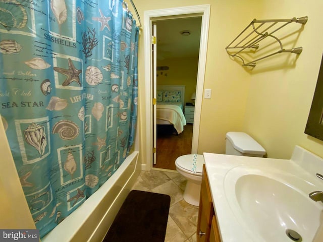 ensuite bathroom with vanity, shower / bathtub combination with curtain, tile patterned floors, toilet, and connected bathroom