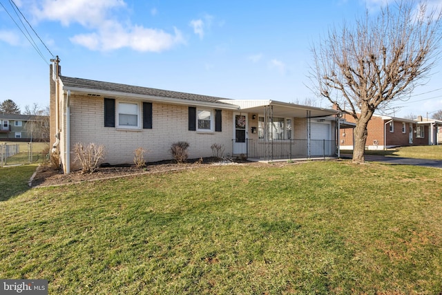 ranch-style house featuring brick siding, an attached garage, a front lawn, fence, and driveway