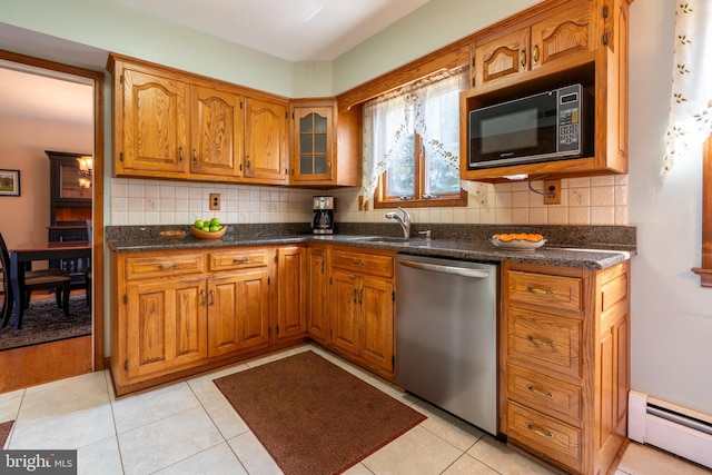 kitchen featuring brown cabinetry, baseboard heating, dishwasher, and black microwave