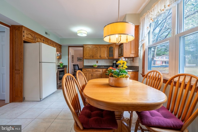 dining room with light tile patterned floors and visible vents