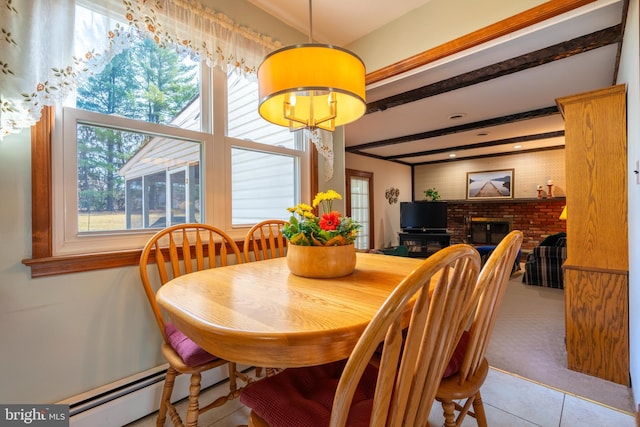 tiled dining space featuring beam ceiling, baseboard heating, and a fireplace