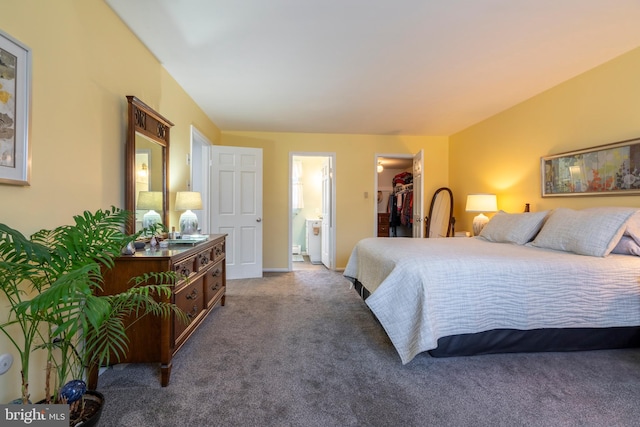 bedroom featuring baseboards, ensuite bath, a spacious closet, a closet, and carpet flooring