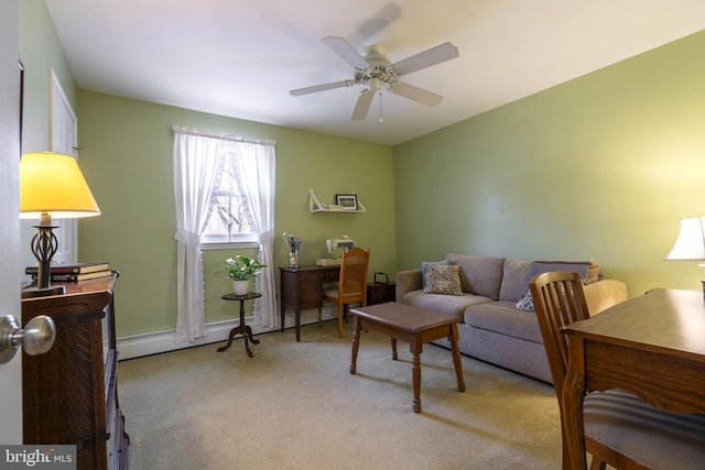 living room featuring ceiling fan, baseboard heating, and light carpet