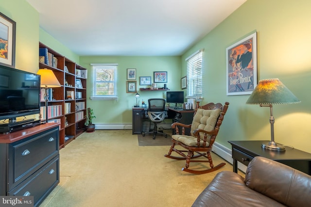 office area with a baseboard radiator, baseboards, and light colored carpet