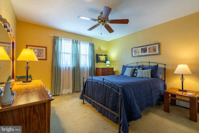 bedroom with a ceiling fan and carpet floors