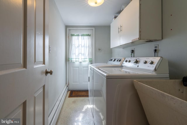 clothes washing area with a sink, a baseboard heating unit, cabinet space, and separate washer and dryer