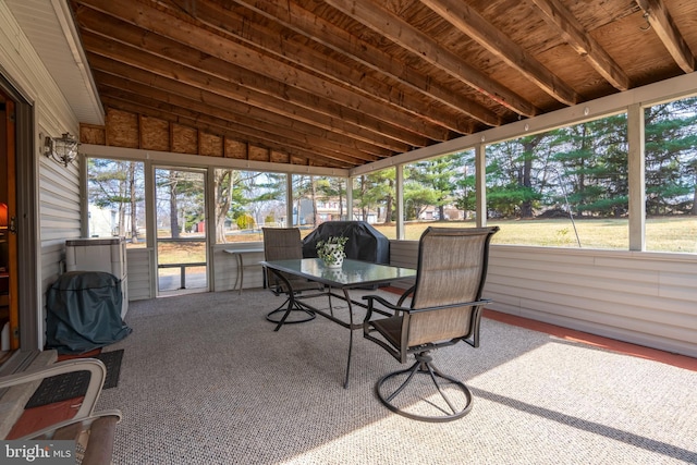 sunroom with lofted ceiling and plenty of natural light