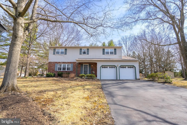 traditional home with aphalt driveway and brick siding