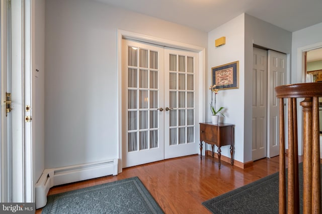 entryway featuring a baseboard radiator, french doors, baseboards, and wood finished floors