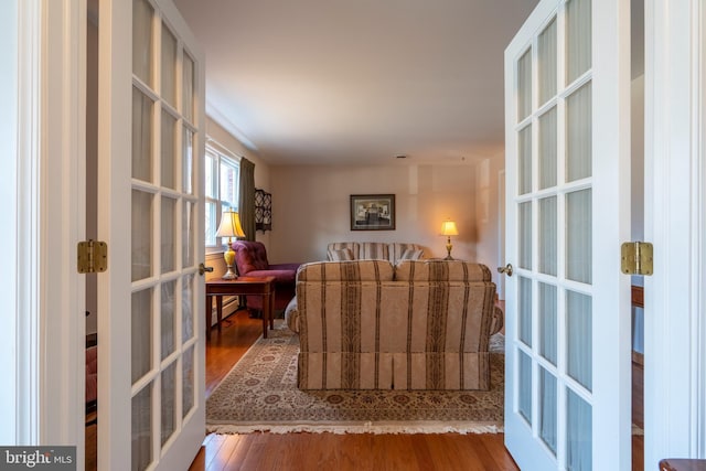 sitting room featuring french doors and wood finished floors