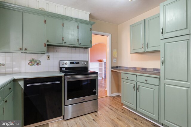 kitchen with arched walkways, electric stove, light wood-style floors, dishwasher, and tasteful backsplash