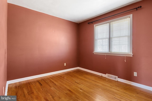 spare room with visible vents, baseboards, and light wood-type flooring