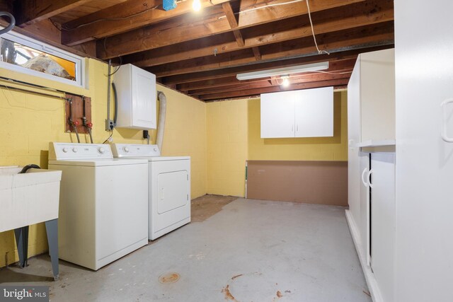 laundry area featuring washer and clothes dryer and cabinet space