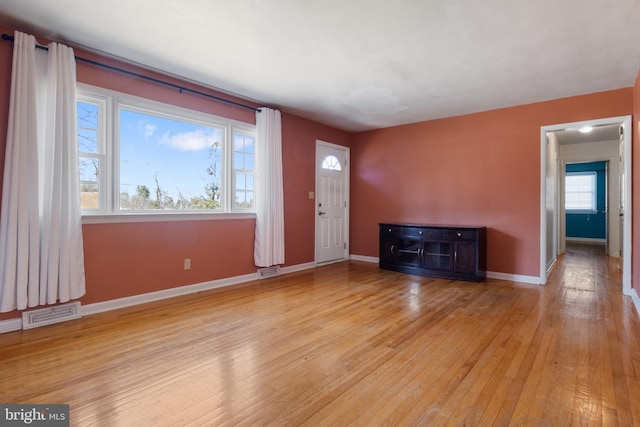 interior space featuring visible vents, baseboards, and light wood-style floors