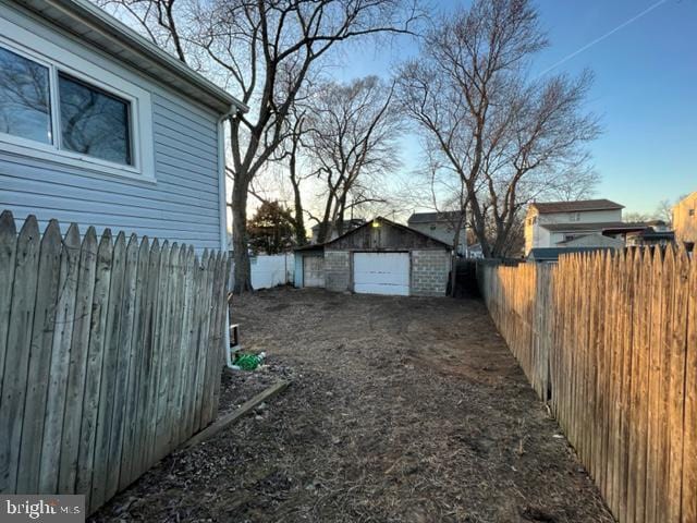 view of yard with a fenced backyard and an outdoor structure