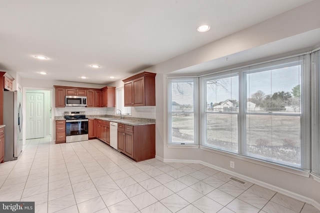 kitchen with visible vents, baseboards, recessed lighting, stainless steel appliances, and a sink