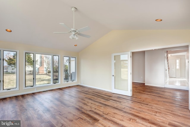 spare room featuring a ceiling fan, wood finished floors, baseboards, recessed lighting, and vaulted ceiling