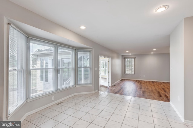 unfurnished room featuring recessed lighting, visible vents, baseboards, and light tile patterned floors