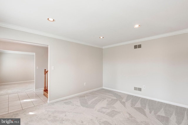 unfurnished room with visible vents, light colored carpet, and crown molding