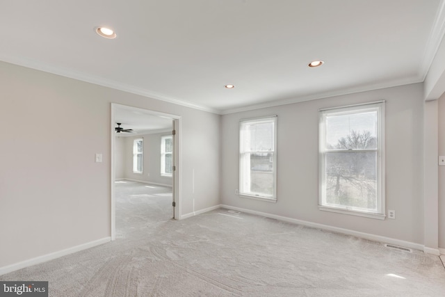 unfurnished room with visible vents, recessed lighting, crown molding, baseboards, and light colored carpet