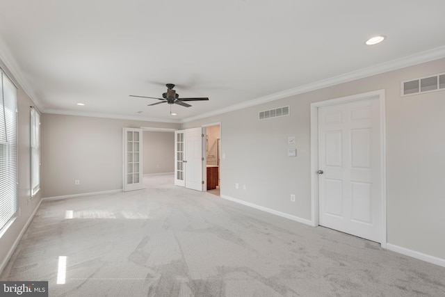 empty room featuring visible vents, french doors, and ornamental molding