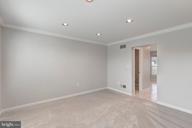 empty room featuring recessed lighting, visible vents, light colored carpet, and ornamental molding