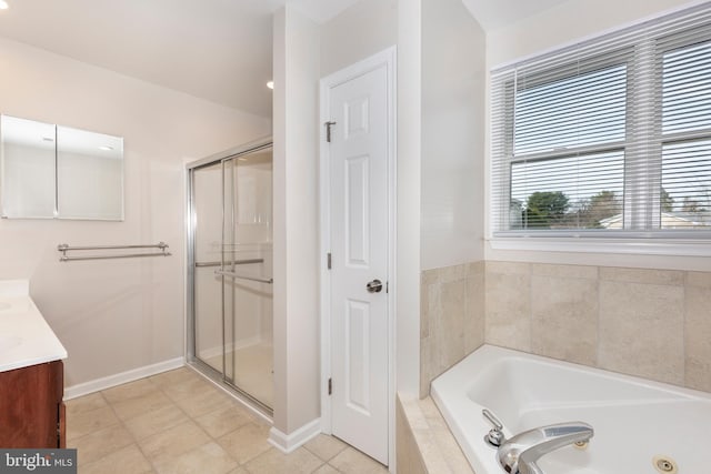 full bath with a stall shower, a tub with jets, tile patterned flooring, baseboards, and vanity