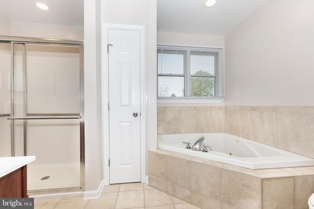 bathroom with tile patterned flooring, recessed lighting, a stall shower, a bath, and vanity