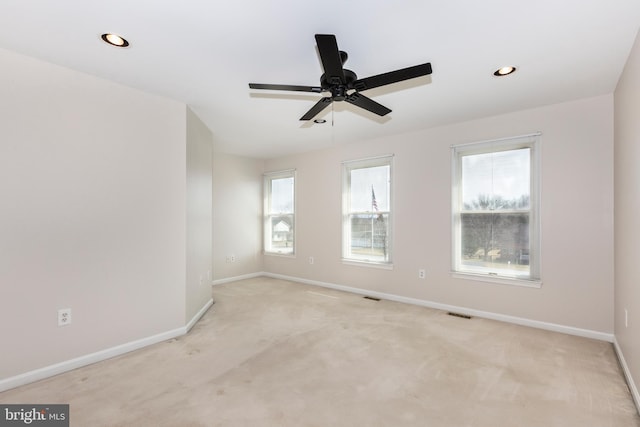 spare room with visible vents, baseboards, light colored carpet, recessed lighting, and a ceiling fan