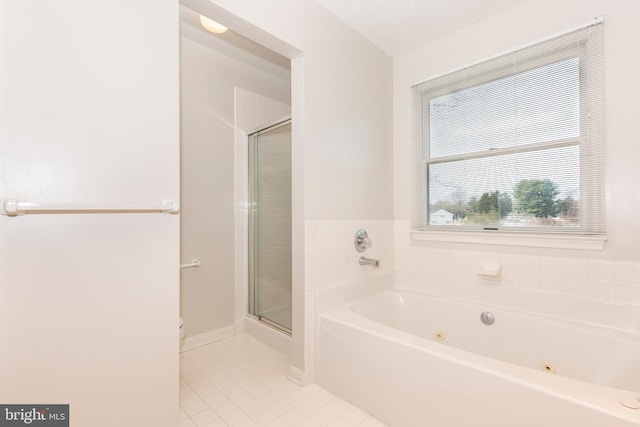 full bathroom featuring tile patterned flooring, a shower stall, baseboards, and a whirlpool tub