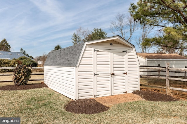 view of shed featuring fence