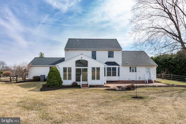 rear view of property featuring entry steps, central AC, fence, a yard, and crawl space