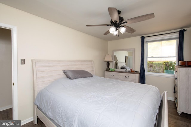 bedroom featuring baseboards, dark wood-type flooring, and ceiling fan