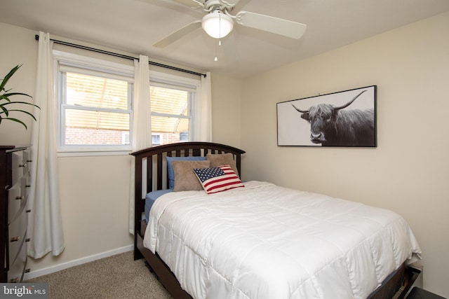 bedroom featuring baseboards, carpet floors, and a ceiling fan