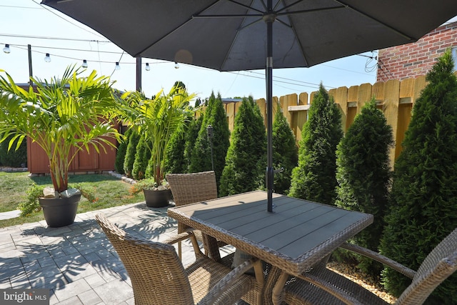 view of patio featuring fence