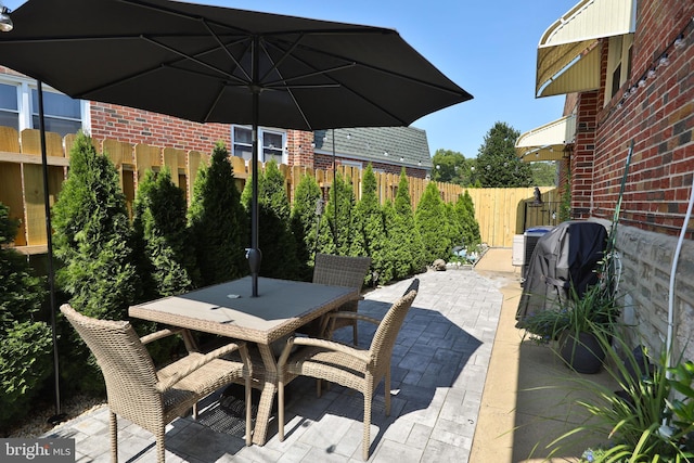 view of patio / terrace featuring outdoor dining space and fence