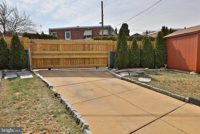 view of patio / terrace with an outdoor structure and fence