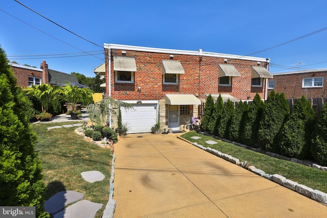 view of front of property featuring concrete driveway, a garage, brick siding, and a front lawn