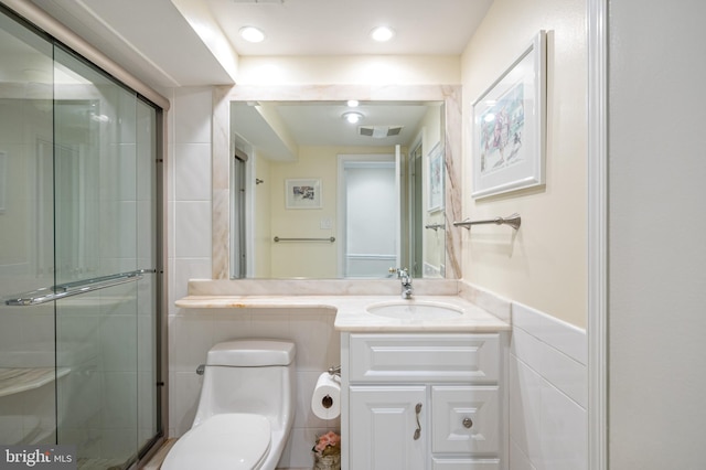 full bath with vanity, a shower stall, toilet, and visible vents