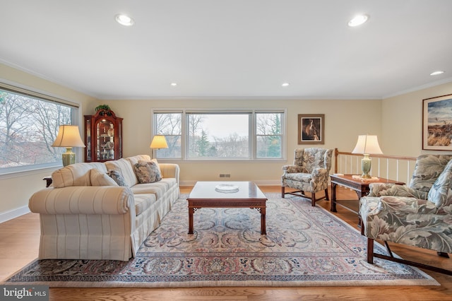 living room featuring visible vents, crown molding, baseboards, recessed lighting, and wood finished floors