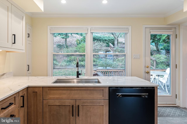 kitchen featuring light stone countertops, plenty of natural light, ornamental molding, a sink, and dishwasher