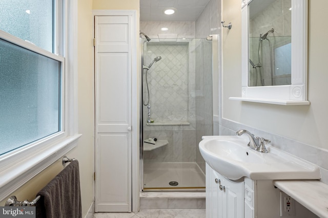 bathroom featuring a shower stall and vanity