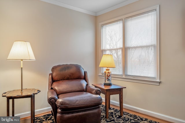 sitting room featuring baseboards, plenty of natural light, wood finished floors, and crown molding