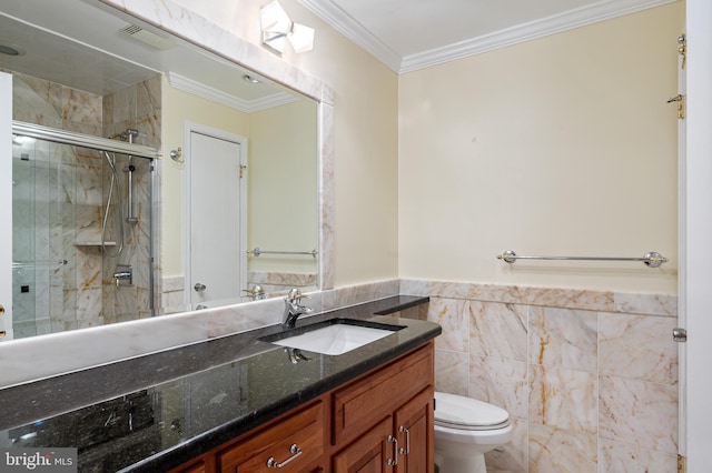 bathroom with toilet, a stall shower, ornamental molding, tile walls, and vanity