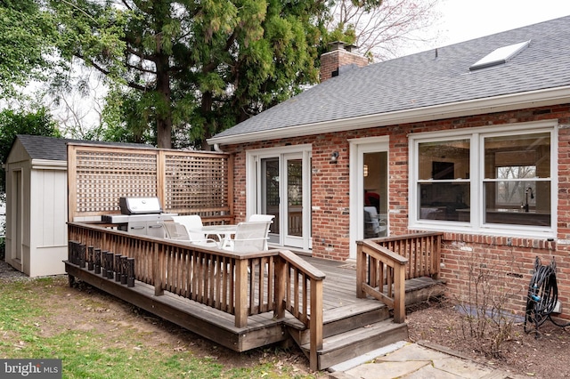 deck with an outbuilding and grilling area