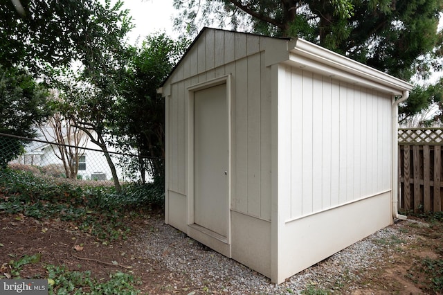 view of shed with fence