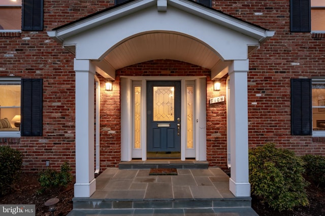 entrance to property with brick siding