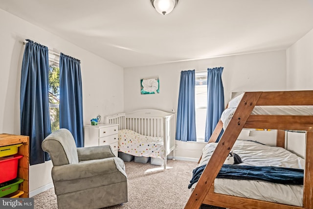 bedroom with baseboards and carpet